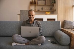 Person sitting on couch with laptop