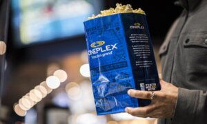 A bag of movie theatre popcorn with the Cineplex logo on it.