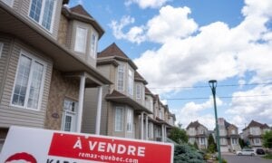 A "for sale" sign is seen in front of a home in Laval, Que., on Friday, July 4, 2025. For the second time this year, the Canadian Real Estate Association has downgraded its forecast for home sales activity in 2025, as it reported that the number of homes that changed hands across the country in June rose 3.5 per cent compared with a year ago.