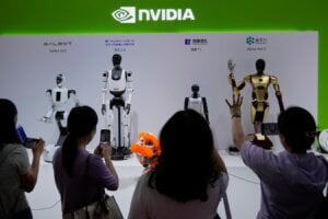 Visitors give commands to a robot at Nvidia's booth during the 3rd China International Supply Chain Expo at the China International Exhibition Center, in Beijing, July 18, 2025.