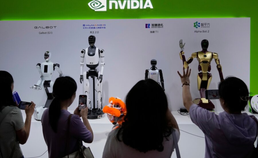 Visitors give commands to a robot at Nvidia's booth during the 3rd China International Supply Chain Expo at the China International Exhibition Center, in Beijing, July 18, 2025.