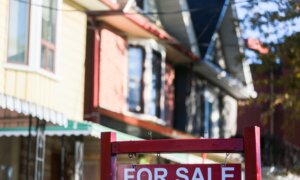 A real estate sign is displayed in front of a house in the Riverdale area of Toronto on Wednesday, Sept. 29, 2021.