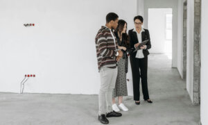 A Canadian landlord showing a property to potential tenants for the 2025 tax year.