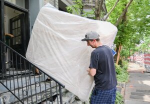 Canada's housing agency says advertised rents in major cities are easing due to factors such as increased supply and slower immigration, but renters are still not feeling relief relative to their income levels. Kyle Jerry, right, helps De-Ren Jhou carry a mattress into an apartment building on Quebec's unofficial moving day in Montreal, Tuesday, July 1, 2025.