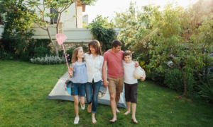 Two parents and two kids in their suburban backyard