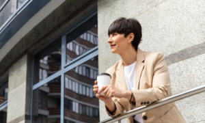 A woman leans on a balcony railing at a condo