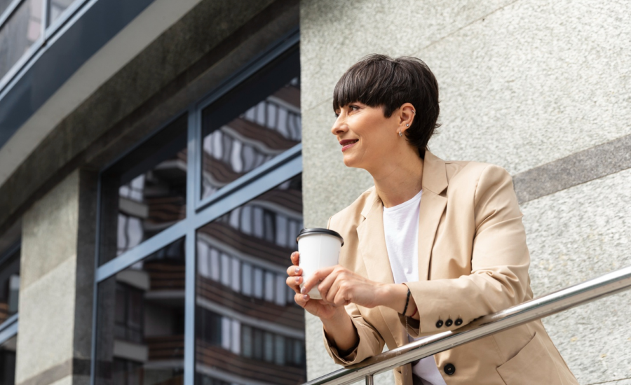 A woman leans on a balcony railing at a condo