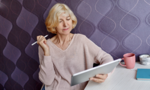 A woman checks her investments on a tablet