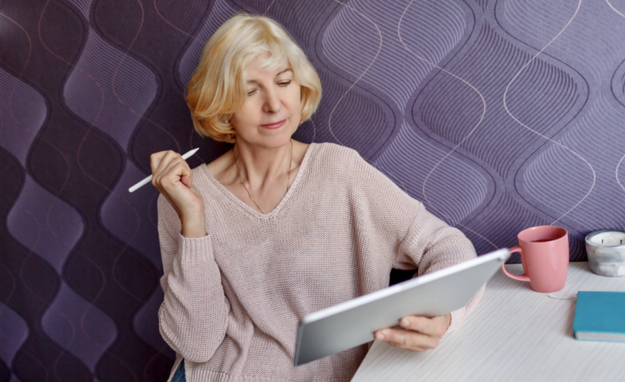 A woman checks her investments on a tablet