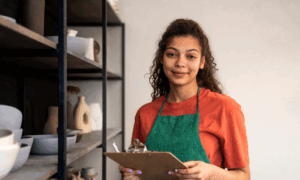 A woman takes inventory in her ceramics shop